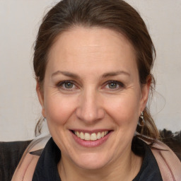 Joyful white adult female with medium  brown hair and brown eyes