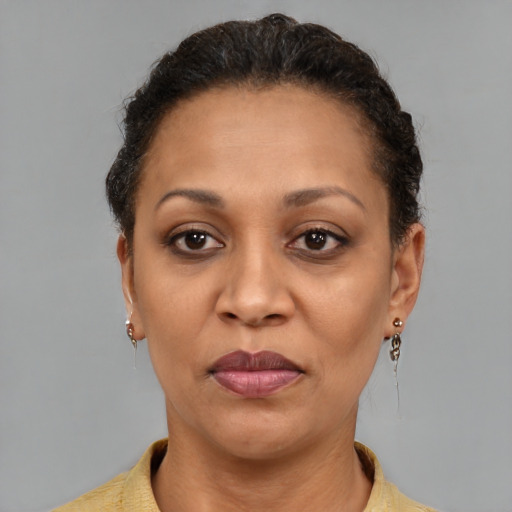 Joyful black adult female with short  brown hair and brown eyes