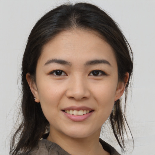 Joyful asian young-adult female with medium  brown hair and brown eyes