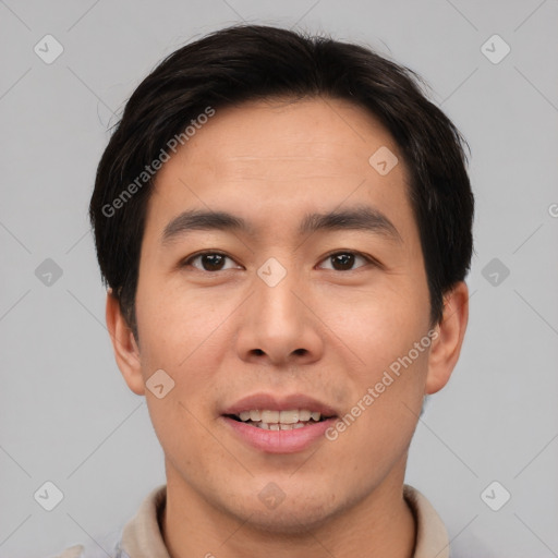 Joyful asian young-adult male with short  brown hair and brown eyes