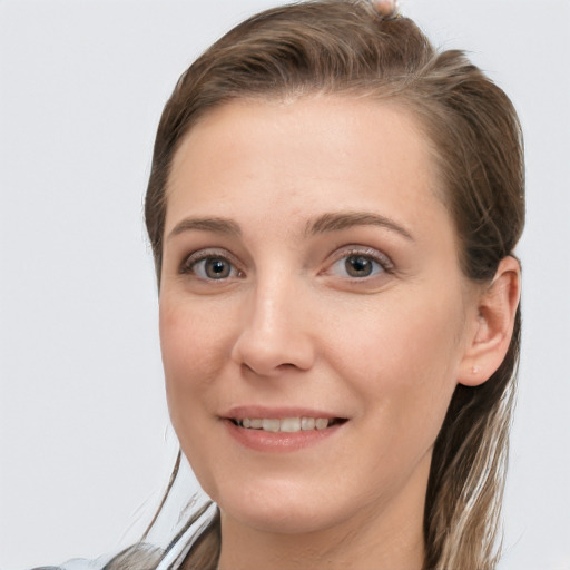 Joyful white young-adult female with long  brown hair and grey eyes