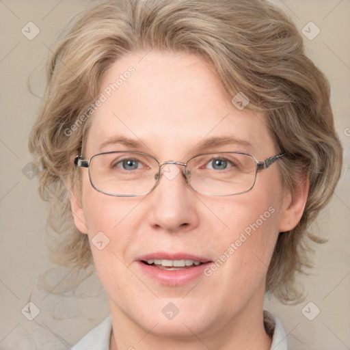 Joyful white adult female with medium  brown hair and blue eyes