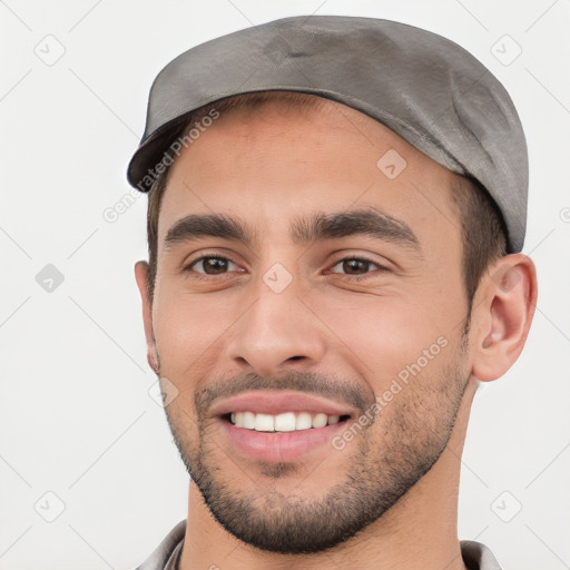 Joyful white young-adult male with short  black hair and brown eyes