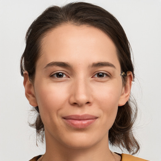 Joyful white young-adult female with medium  brown hair and brown eyes