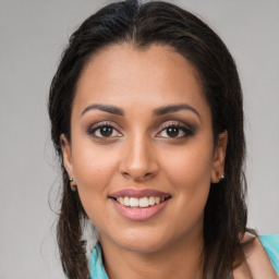 Joyful latino young-adult female with medium  brown hair and brown eyes