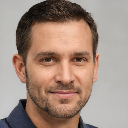 Joyful white adult male with short  brown hair and brown eyes