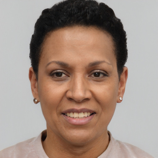 Joyful latino adult female with short  black hair and brown eyes