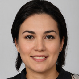 Joyful white young-adult female with medium  brown hair and brown eyes