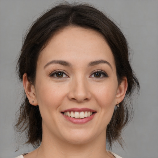 Joyful white young-adult female with medium  brown hair and brown eyes