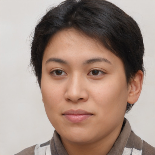 Joyful asian young-adult female with short  brown hair and brown eyes