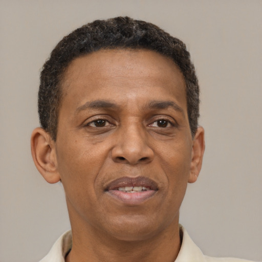 Joyful black adult male with short  brown hair and brown eyes