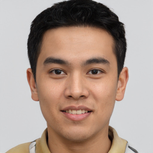 Joyful latino young-adult male with short  brown hair and brown eyes