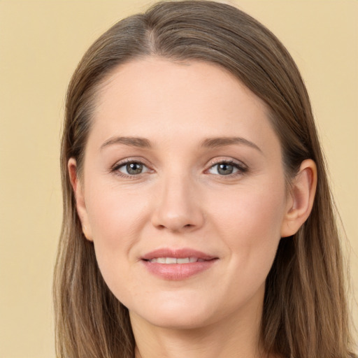 Joyful white young-adult female with long  brown hair and grey eyes