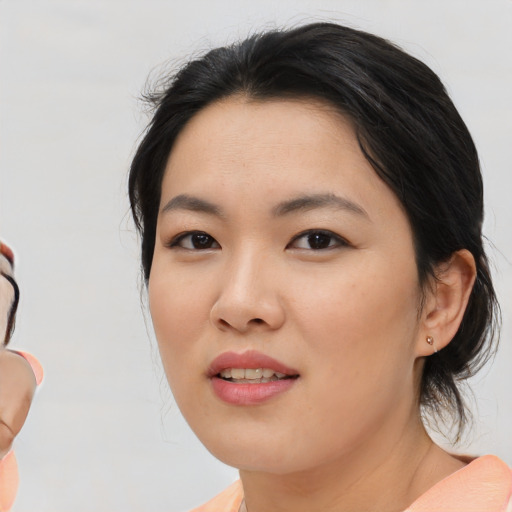 Joyful asian young-adult female with medium  black hair and brown eyes