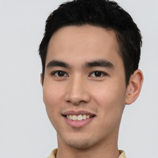 Joyful asian young-adult male with short  black hair and brown eyes