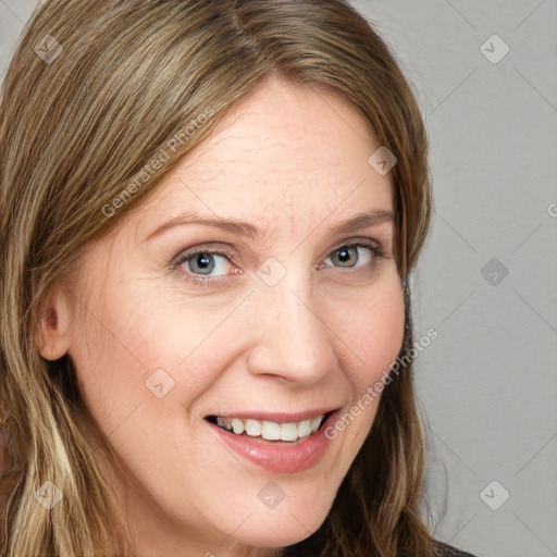 Joyful white young-adult female with long  brown hair and blue eyes