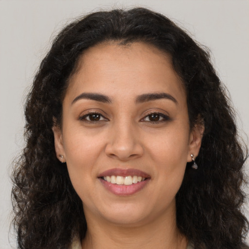 Joyful latino young-adult female with long  brown hair and brown eyes