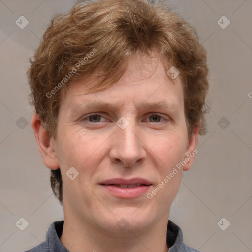 Joyful white adult male with short  brown hair and grey eyes