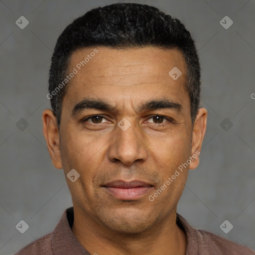Joyful white adult male with short  black hair and brown eyes