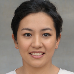 Joyful asian young-adult female with short  brown hair and brown eyes