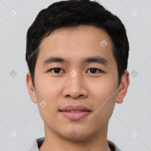 Joyful asian young-adult male with short  black hair and brown eyes