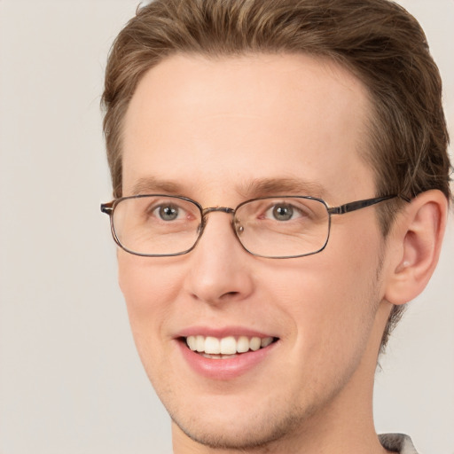 Joyful white adult male with short  brown hair and grey eyes