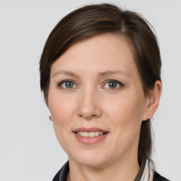 Joyful white adult female with medium  brown hair and grey eyes