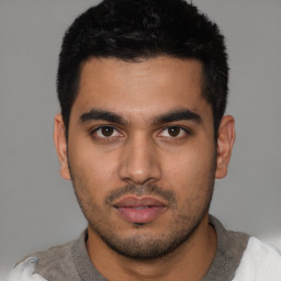 Neutral latino young-adult male with short  black hair and brown eyes