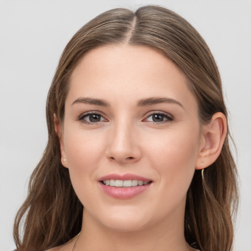 Joyful white young-adult female with long  brown hair and grey eyes