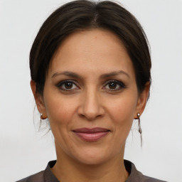 Joyful white adult female with medium  brown hair and brown eyes