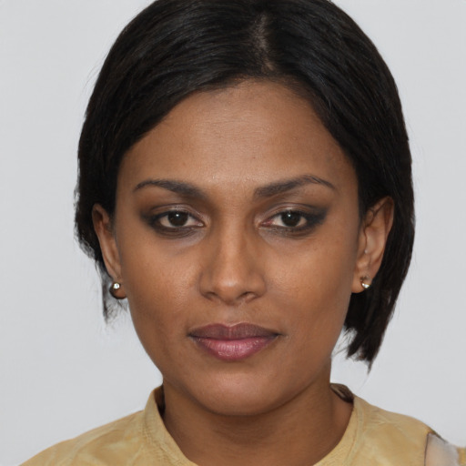 Neutral black young-adult female with medium  brown hair and brown eyes