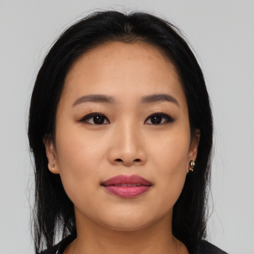 Joyful asian young-adult female with long  black hair and brown eyes