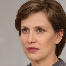 Joyful white adult female with medium  brown hair and grey eyes