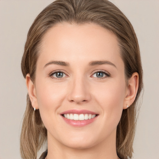 Joyful white young-adult female with medium  brown hair and grey eyes