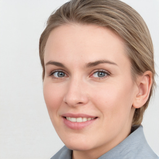 Joyful white young-adult female with medium  brown hair and blue eyes