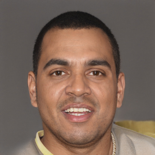 Joyful latino young-adult male with short  brown hair and brown eyes