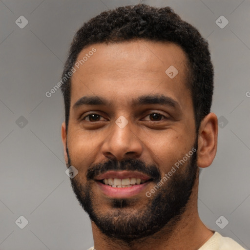 Joyful black young-adult male with short  black hair and brown eyes