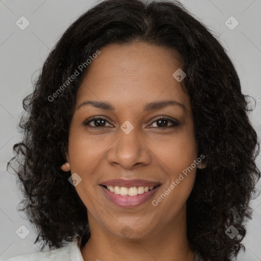 Joyful black young-adult female with long  brown hair and brown eyes