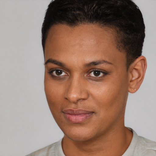 Joyful black young-adult female with short  brown hair and brown eyes