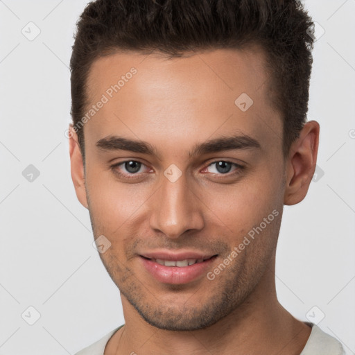 Joyful white young-adult male with short  brown hair and brown eyes