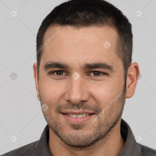 Joyful white young-adult male with short  brown hair and brown eyes