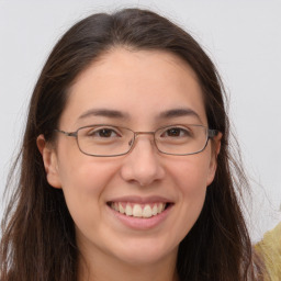 Joyful white adult female with long  brown hair and brown eyes