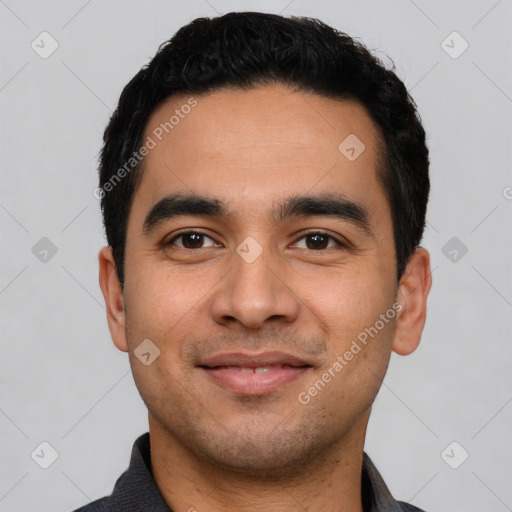 Joyful latino young-adult male with short  black hair and brown eyes