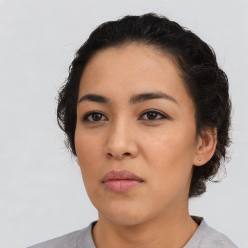 Neutral latino young-adult female with medium  black hair and brown eyes