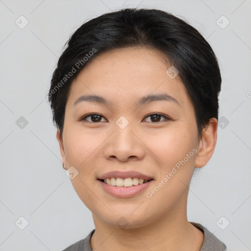 Joyful asian young-adult female with short  black hair and brown eyes