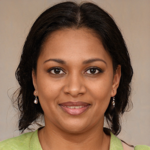 Joyful black young-adult female with medium  brown hair and brown eyes