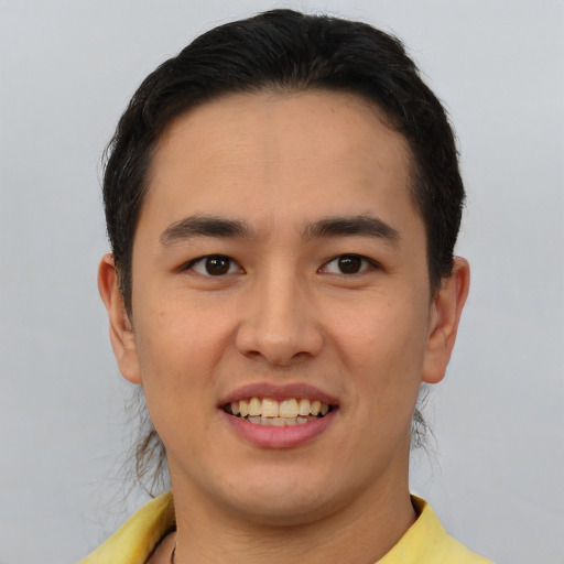 Joyful white young-adult male with short  black hair and brown eyes
