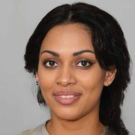 Joyful latino young-adult female with medium  black hair and brown eyes