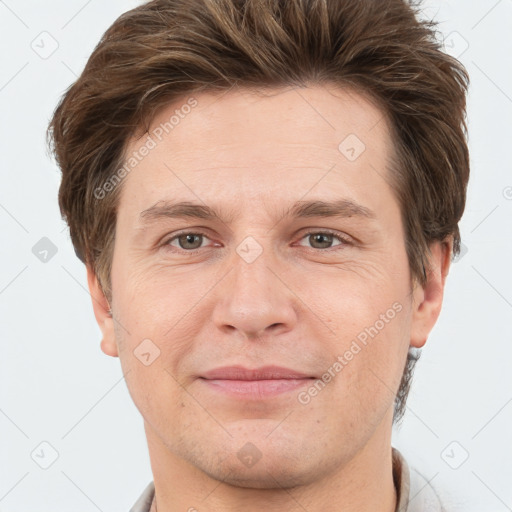 Joyful white adult male with short  brown hair and grey eyes