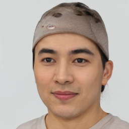 Joyful asian young-adult male with short  brown hair and brown eyes